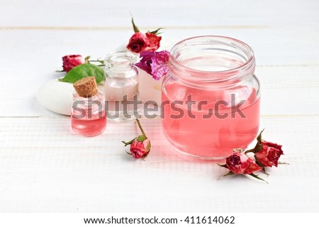 Aroma rose water for skincare, essential oils, jar and bottle, dried flowers.