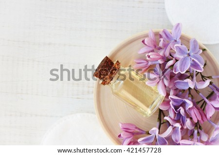 Relaxing essential oil, fresh flowers, relaxation setting, top view.