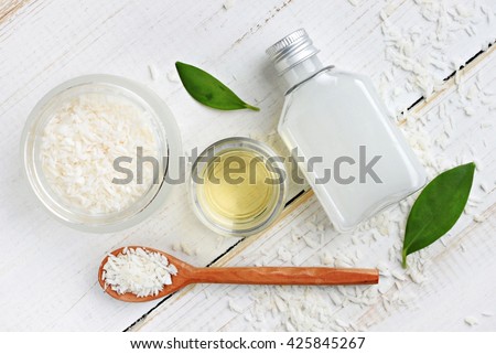 Coconut cosmetic products. Coconut shavings, oil, milk. Healthy skincare. Top view background.