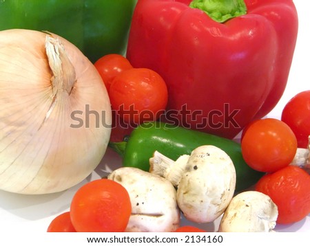 close-up of some vegetables such as onion, red and green pepper, cherry tomatoes, jalapenos and mushrooms.
