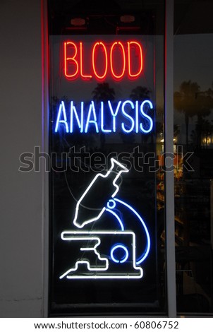 Blood analysis neon sign isolated on a window panel
