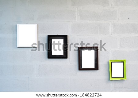 empty photo frames on white concrete wall