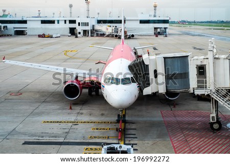 BANGKOK/THAILAND-MAY  16 : Air Asia aircraft docking at  Don Mueang International Airport on May 16, 2014. Don Muang is  the main hub for low cost airlines.