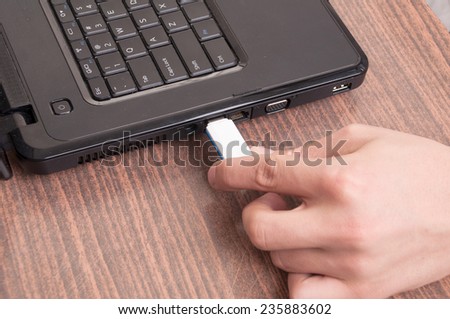 Hand Inserting usb memory stick to laptop computer