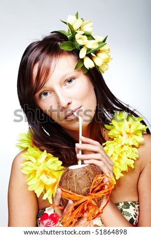 stock photo Beautiful exotic girl with Hawaiian accessories drinking