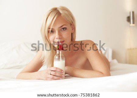 Young beautiful woman drinking milk