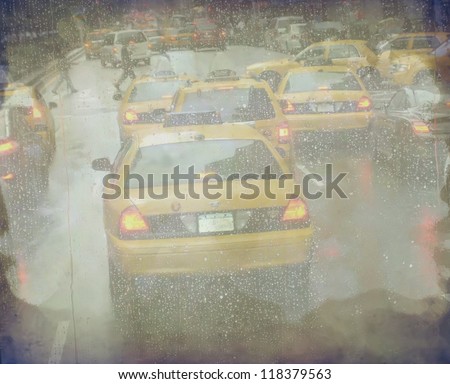 Grunge defocused Manhattan taxi cabs during the rain