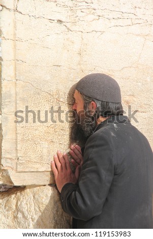 JERUSALEM, ISRAEL - MARCH 13 : Unidentified jewish man prays at the Wailing wall (Western wall) on March 13, 2012 in Jerusalem, Israel