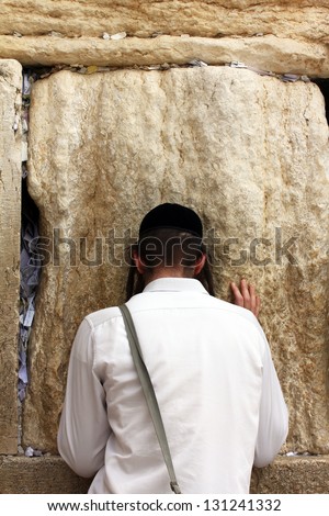 Unidentified young man praying at the Wailing wall (Western wall)