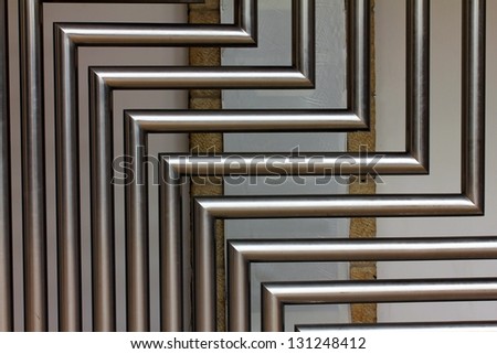 A stainless steel tubes against the wall