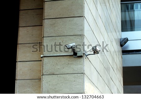 Two security cameras attached on the office building corner