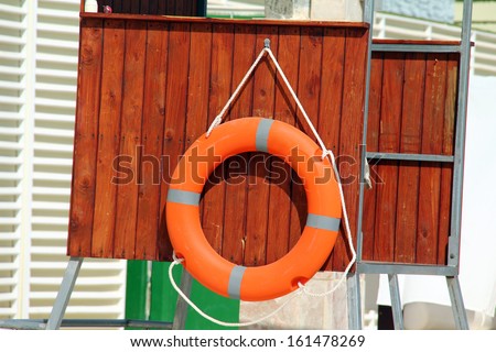 Lifeguard tower at the swimming pool and lifebuoy