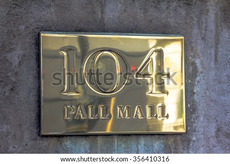 LONDON, UK - JUNE 4, 2015:  Gold sign PALL MALL 104 on the stone wall