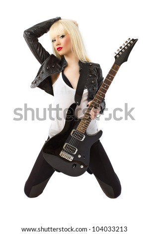 Sexy beautiful blonde woman in black leather jacket posing with black electric guitar