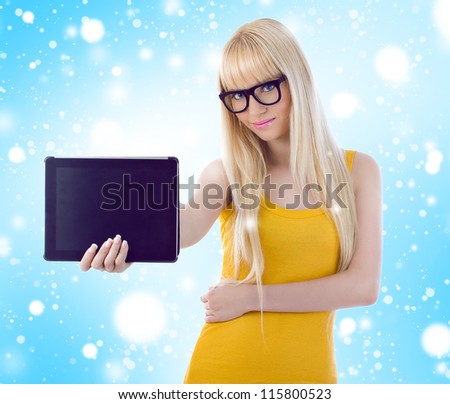 Woman showing tablet computer screen smiling wearing glasses. Snowflakes