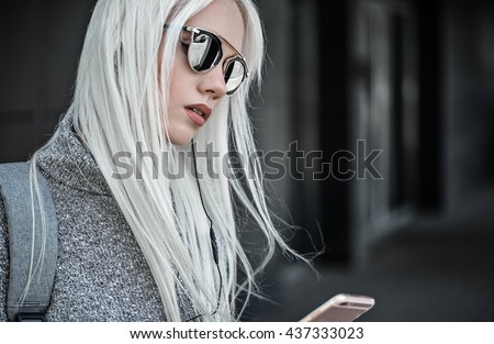 Beautiful blonde girl in posing outdoors