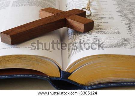 Wood cross on a page of the bible