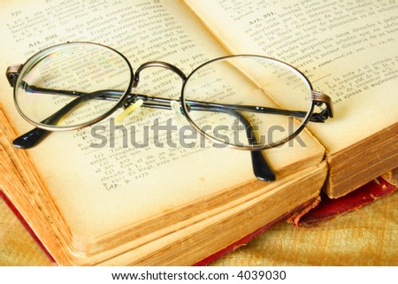 Old glasses over a vintage book of law