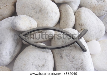 Christian religious Fish sign over white pebbles