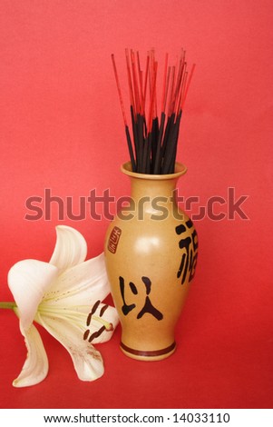 Incense sticks in a Chinese jug and Madonna lily