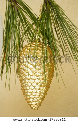 Golden decoration holding from the pine tree