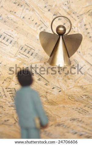 Boy and angel with a music sheet as back ground