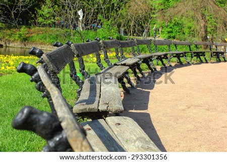 Many benches in summer park located half circle