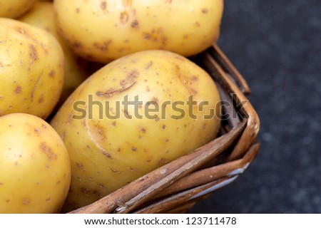 Washed organic baking potato\'s in a farm house wooden basket