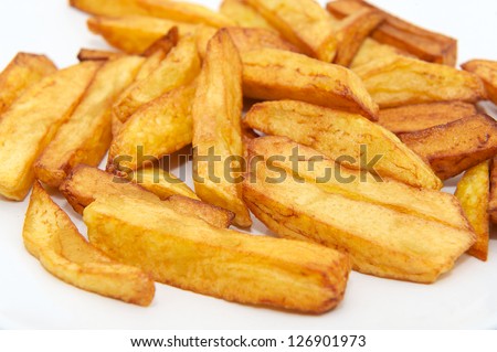 Freshly cooked steak cut chips fresh out of the hot oil from the fryer, isolated on white