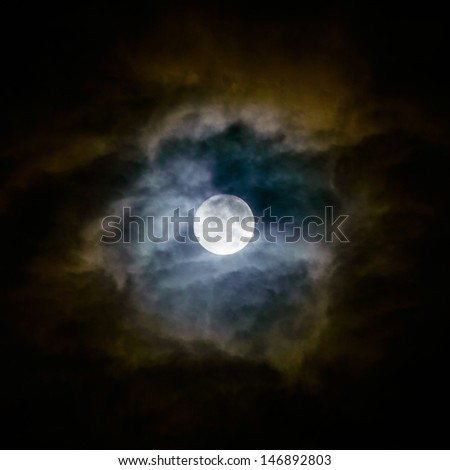 Full moon and clouds on night sky.