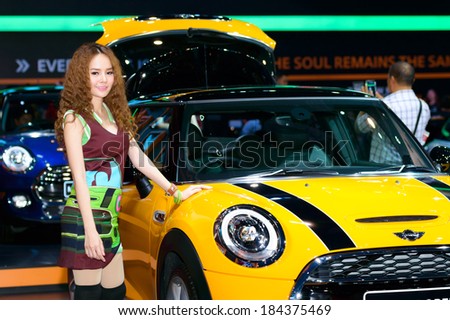 BANGKOK - MARCH 27 : Female presenters model at the Mini Cooper booth during at The 35th Bangkok International Motor Show - Beauty in the Drive\' on March 27, 2014 in Bangkok, Thailand.
