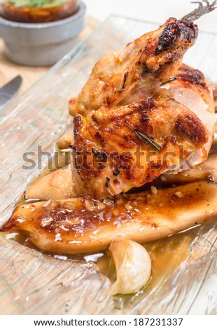 Grilled chicken breast with Mushroom on Glass Dish.