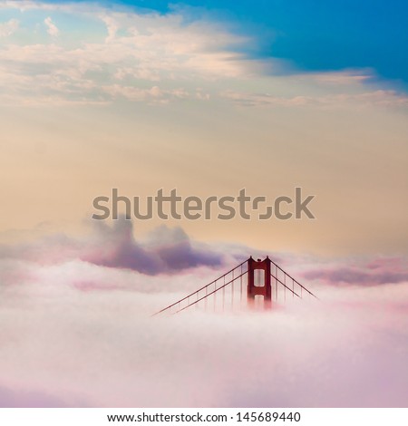 World Famous Golden Gate Bridge Surrounded By Fog After Sunrise In San Francisco,California