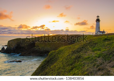 Yaquina Head Lighthouse By The Oregon Coast On A Beautiful Sunset