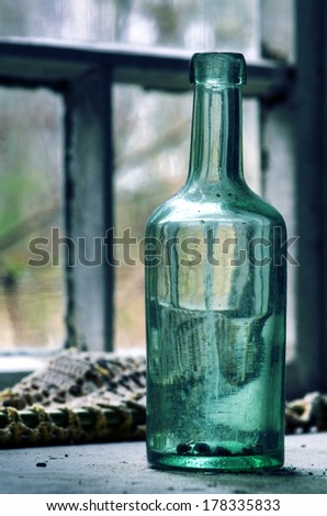 Old bottle in abandoned farm house at Southern Finland. Urban exploration.