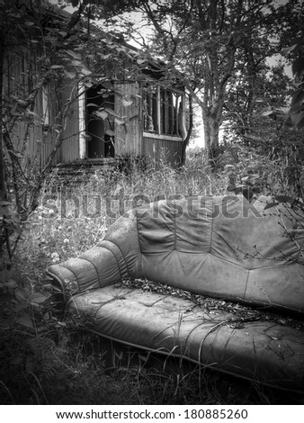 Sofa at abandoned house\'s garden at Southern Finland.