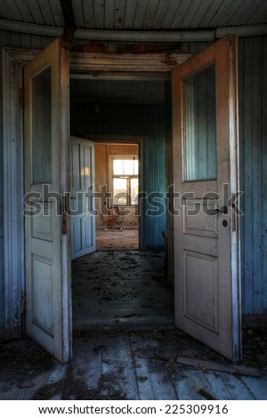 Open doors - view from old, abandoned farm house in Southern Finland. Urban exploration.