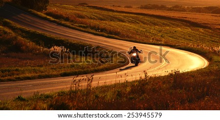 Motorcycle on the road at September evening.