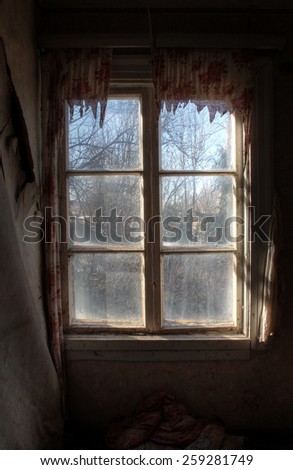 Window view from old, abandoned farm house at spring morning.