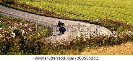 Motorcycle on the road at summer evening in Southern Finland.