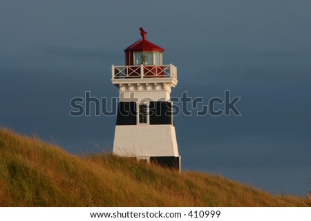 quaint summer-side lighthouse watching the coast of Prince Edward Island