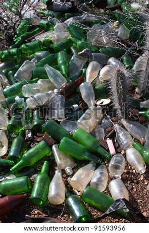 Pollution background. Loads of glass bottles dumped in nature. (glass can be recycled)