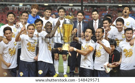 BANGKOK,THAILAND-JULY13:Singha All Star Team Celebrate with the winner trophy during the friendly match between Singha All Star and Manchester United at Rajamangala Stadium on July13,2013 inThailand.
