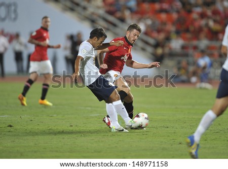 BANGKOK,THAILAND-JULY13: Michael Carrick(R1)of Manchester United in action during the friendly match between Singha All Star and Manchester United at Rajamangala Stadium on July 13, 2013 in Thailand.