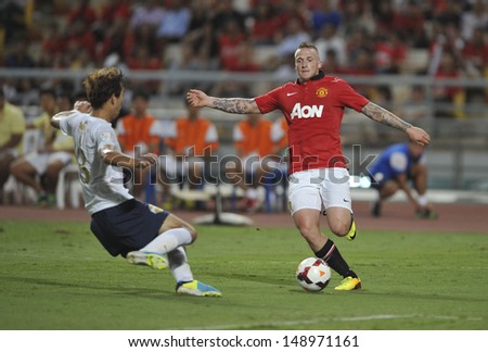 BANGKOK,THAILAND-JULY13: Alex Buttner(R) of Manchester United in action during the friendly match between Singha All Star and Manchester United at Rajamangala Stadium on July 13, 2013 in Thailand.