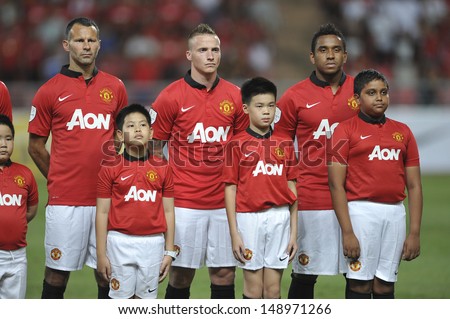 BANGKOK,THAILAND-JULY13: Ryan Giggs(L1) of Manchester United in action during the friendly match between Singha All Star and Manchester United at Rajamangala Stadium on July 13, 2013 in Thailand.