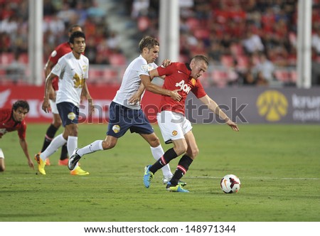 BANGKOK,THAILAND-JULY13: Tom Cleverley(R1) of Manchester United in action during the friendly match between Singha All Star and Manchester United at Rajamangala Stadium on July 13, 2013 in Thailand.