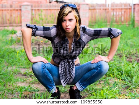 Beautiful girl sitting on ground leaning his hands on his knees