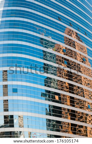 Abstract background texture with buildings reflected in windows of modern office building