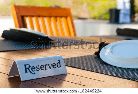 Reserved sign on a table in restaurant - selective focus